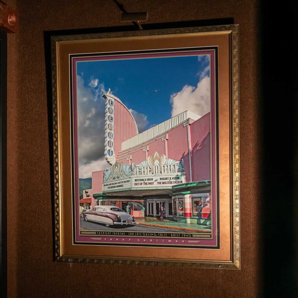 Framed Larry Grossman Fremont Theatre Art Print: This vibrant, Art Deco-style lithograph by renowned artist Larry Grossman captures the iconic Fremont Theatre in San Luis Obispo, California. Built in 1940, the theatre's signature "streamline moderne