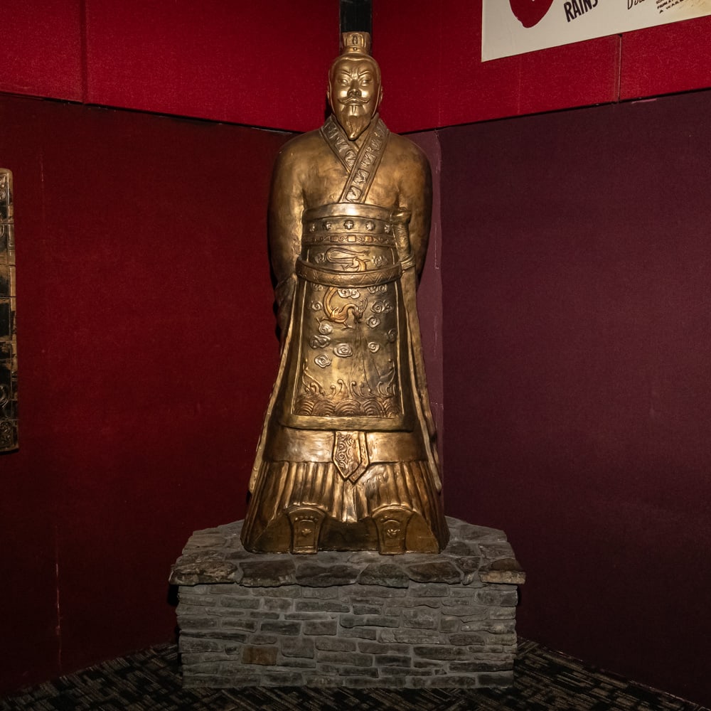 Large Chinese Immortal Cast Resin Statue-HEAVY: This imposing figure captures the stoic dignity of a Chinese scholar or immortal, rendered in a striking bronze-tone finish over what appears to be a durable cast resin or composite material. The atti