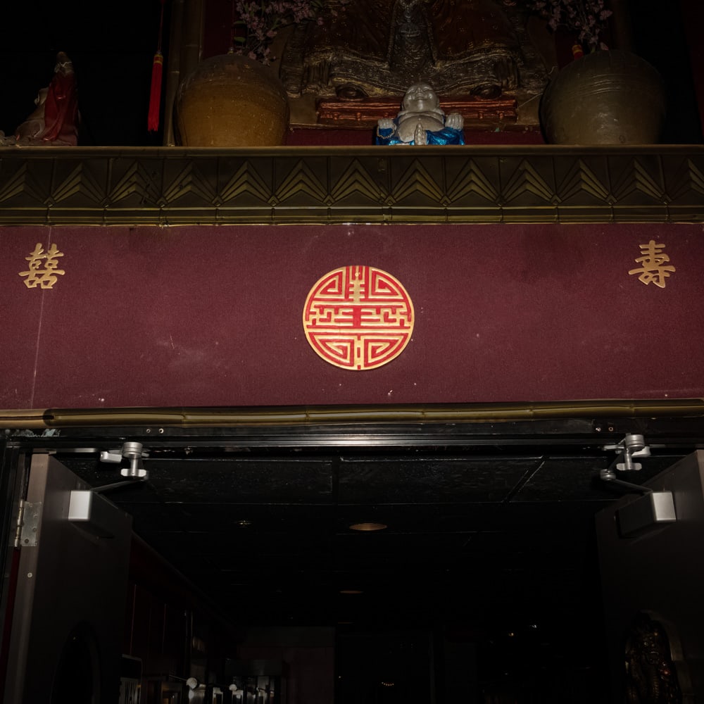 Chinese Brass Double Happiness & Shou Symbols: This lot features three traditional Chinese auspicious symbols crafted from cast metal with a classic brass-toned finish. Included is a central 12-inch circular medallion featuring an intricate, styli