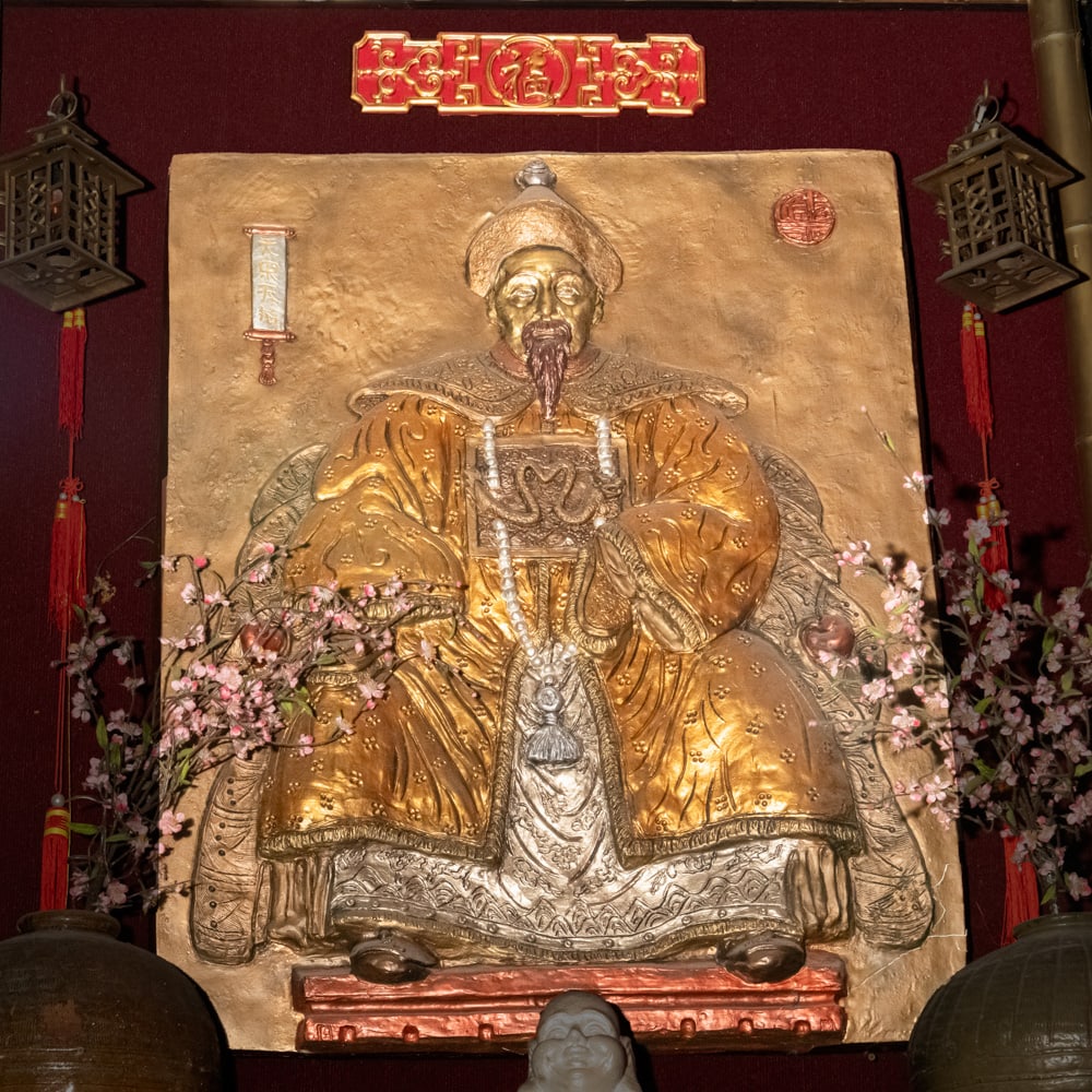 Vintage Gilt Chinoiserie Emperor Plaque: This striking high-relief wall hanging captures the ornate spirit of mid-20th-century Chinoiserie decor, styled to resemble an imperial Chinese portrait. The figure, likely a composite or cast resin m