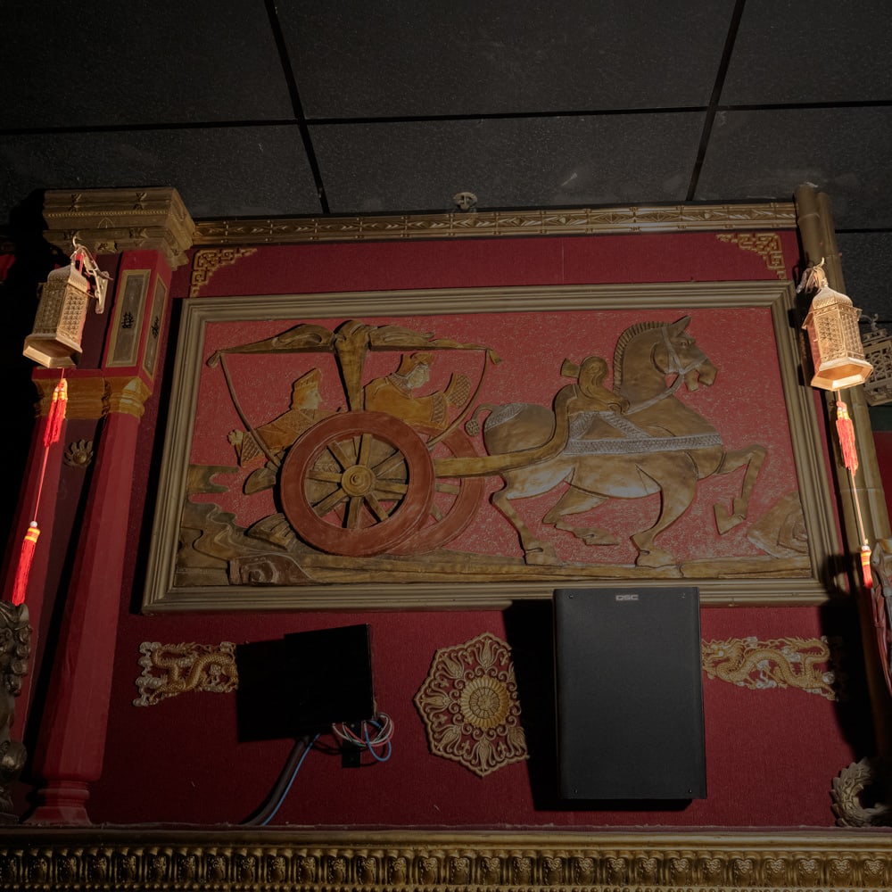 Pair Electric Brass Asian/Eastern Lantern On Hooks: This pair of ornate, electrified lanterns showcases an elegant Asian-inspired aesthetic, featuring intricate geometric openwork and refined metal craftsmanship. Crafted from brass-toned metal, each la