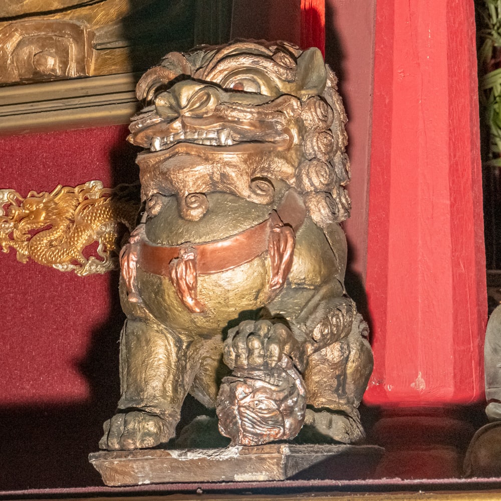 2nd Level Gold-Finished Imperial Guardian Lion (L): A classic and auspicious representation of a Chinese Guardian Lion, or "Shi," likely of 20th-century manufacture. This piece captures the traditional "male" form, depicted with his right paw resting a