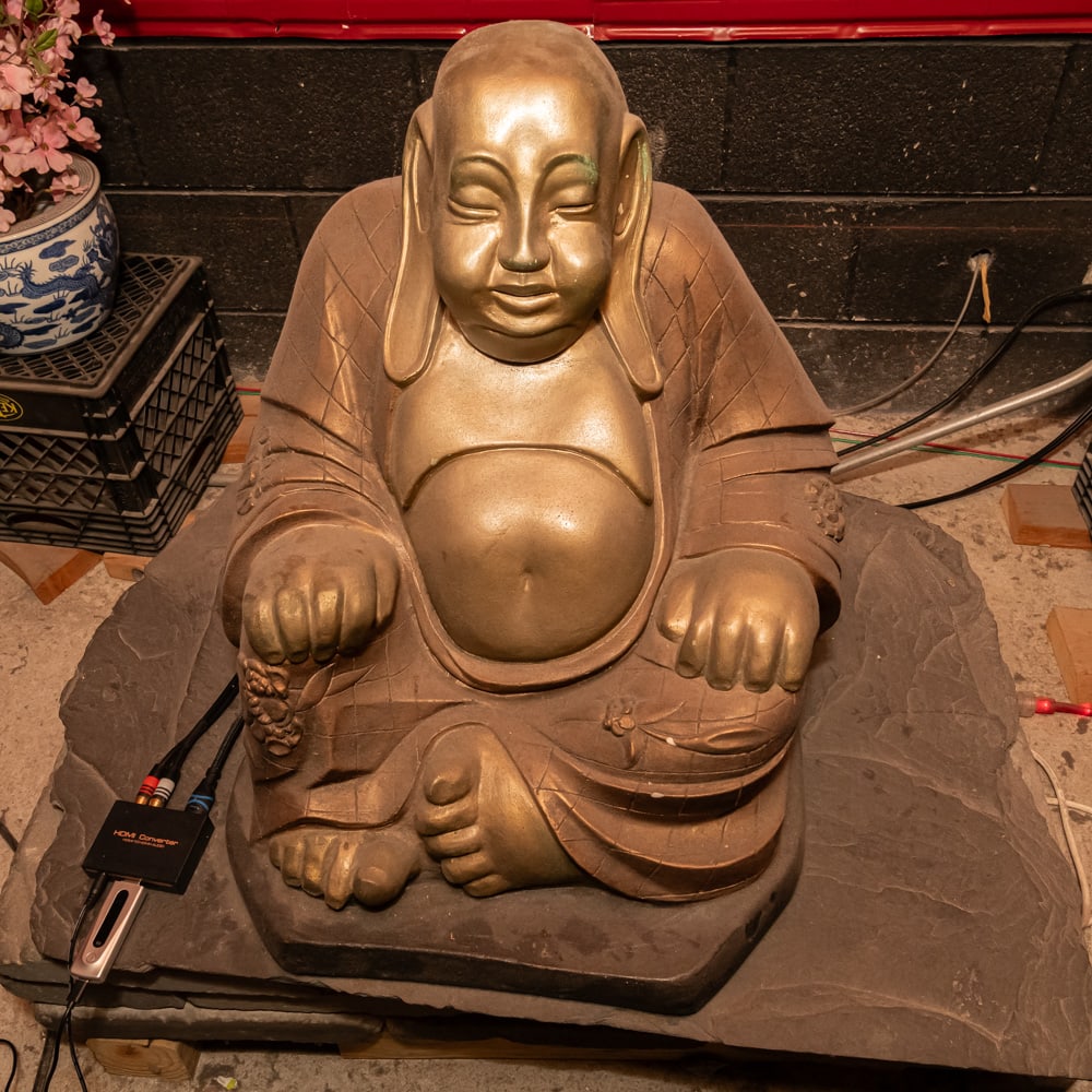 Large Seated Painted Terra Cotta Buddha: Note: Pickup/Transport required. Contacts available post auction. This imposing Hotei, or "Laughing Buddha," is a classic symbol of happiness and abundance, masterfully rendered in heavy terra cotta.