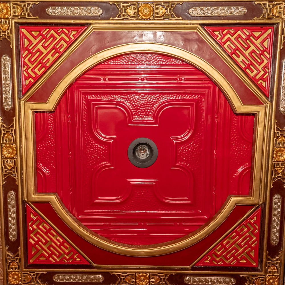 Ornate Asian-Style Red Ceiling Tile: This striking architectural element features a classic Asian-inspired aesthetic, characterized by a deep cinnabar-red center with a raised floral or "four-petal" motif and a textured "orange peel" bac