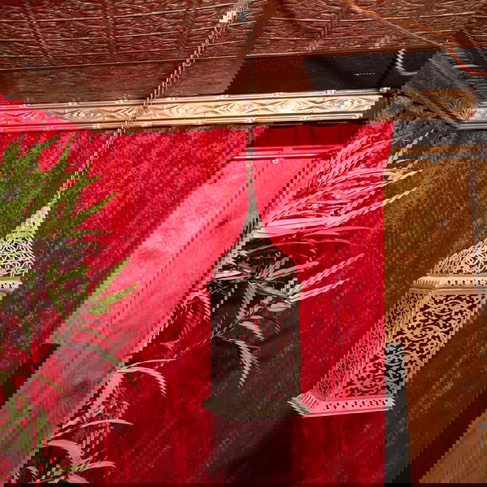 Pair Vintage Moorish Style Metal Lanterns: This striking electrified pendant lantern captures the exotic elegance of Moorish-revival design, featuring intricate fretwork that casts dramatic shadows when illuminated. Constructed from a silver-t