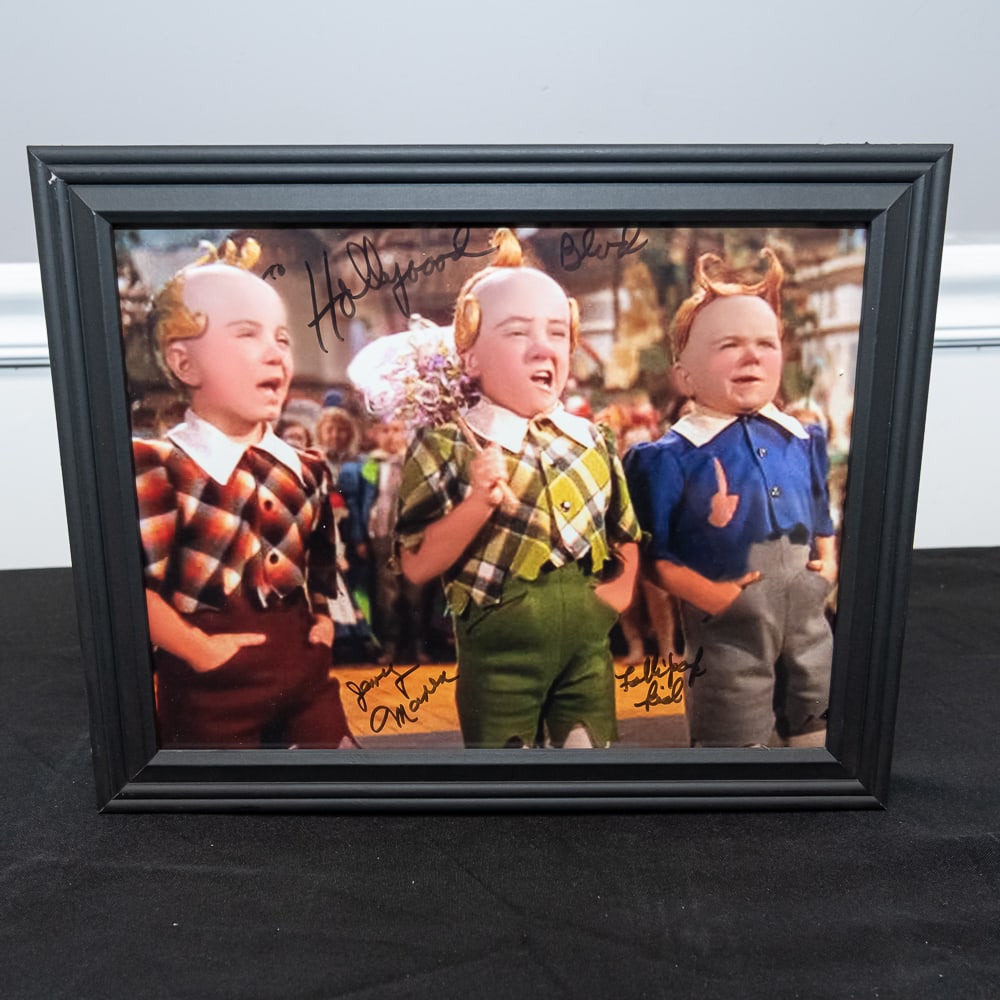 Signed Wizard of Oz Lollipop Guild Photo 12"x15": This charming piece of cinematic history captures the iconic Lollipop Guild from the 1939 MGM classic The Wizard of Oz. This specific color still is hand-signed by Jerry Marren (the center Munchkin wh