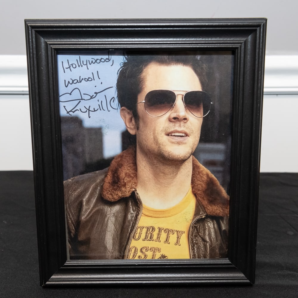 Framed Johnny Knoxville Signed 8x10 Photo: This is a classic piece of modern pop culture memorabilia featuring Johnny Knoxville, the mastermind behind the Jackass franchise. The color photograph captures Knoxville in his signature daredevil-co