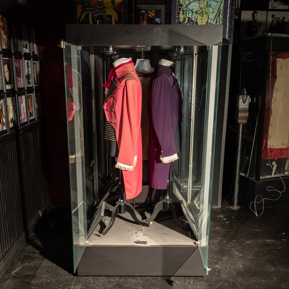 Large Glass Floor Case: Large glass floor showcase on wheels with hinged doors on one side. In good condition. Doors have locks but no key is provided. Contents of case not included. Please use photos to judge condition