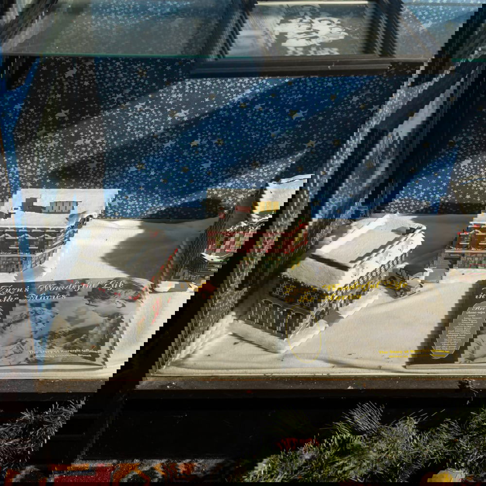 It's a Wonderful Life Movie Stills: Lot includes 9 framed 8 X 10 B&W stills from It's a Wonderful Life, 5 Hallmark Christmas Village buildings, and 3 books written by Karoline Grimes who played little Zuzu in the movie. In good