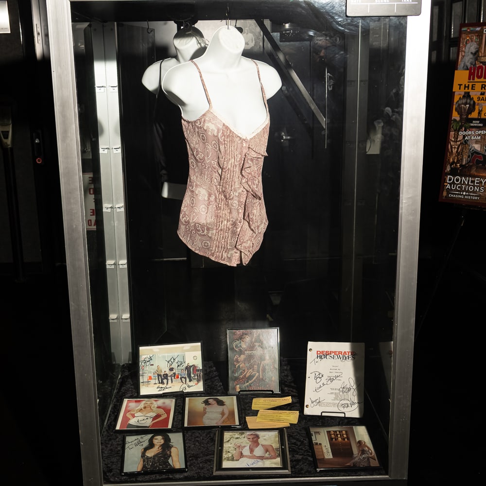 Desperate Housewives Nighties: Lot includes 2 screen worn nighties from the TV show, Desperate Housewives, 2 display torsos, a cast signed Pilot Shooting script, 6 cast signed 8 X 10 color photos, three 2009 NBC Set Passes, and a