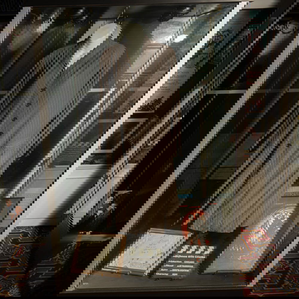 Dress From The Movie "Chicago": Screen worn costume by Diedre Goodwin as the character June in the 2002 movie, Chicago. In good condition. Comes with display torso and a prop letter also used in the movie. Glass display case sold as