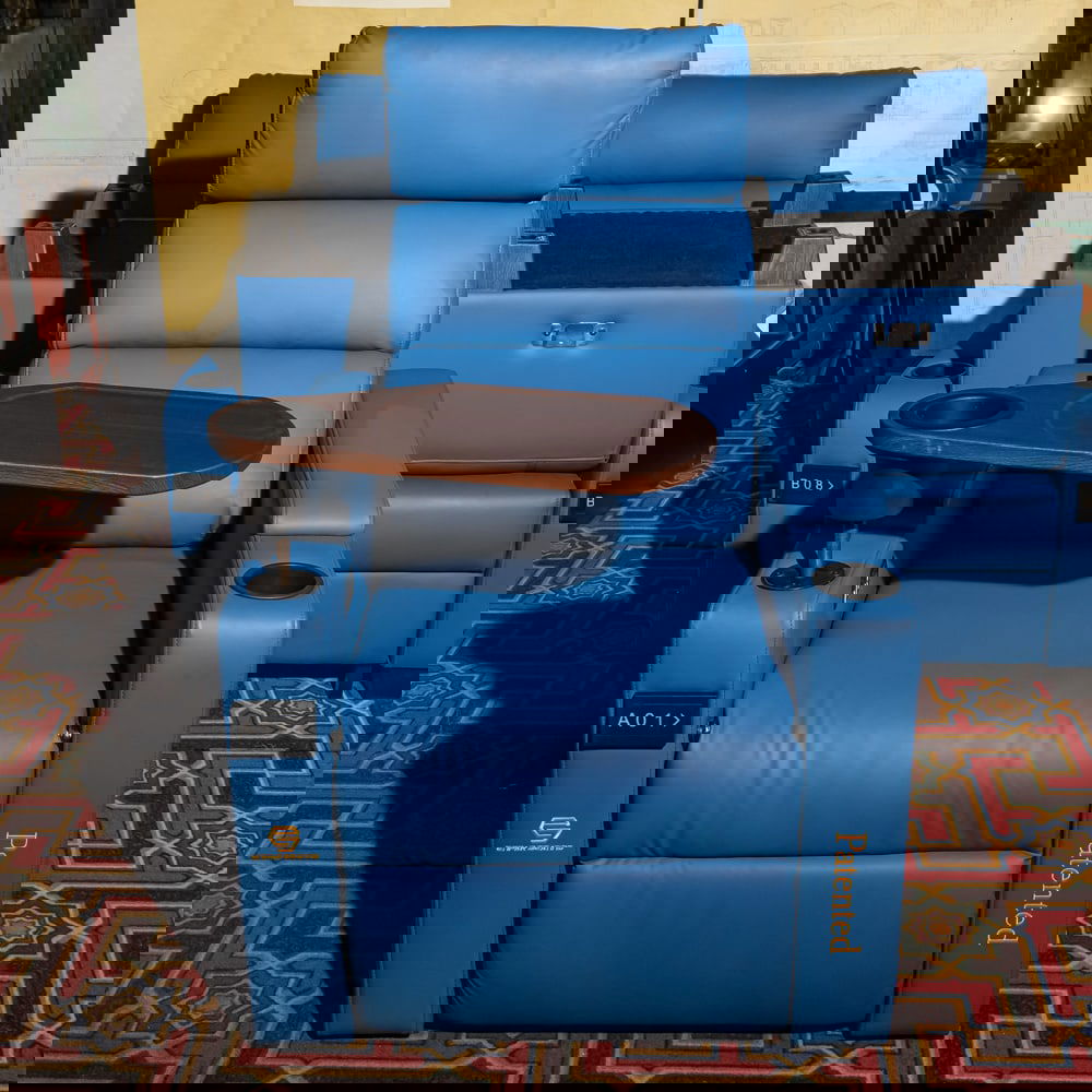 Blue Leather Cinema Recliner w/ Tray: This is a professional-grade, modern cinema recliner upholstered in a vibrant blue leather or high-quality faux leather, featuring a integrated swivel wooden snack tray and dual cup holders. The