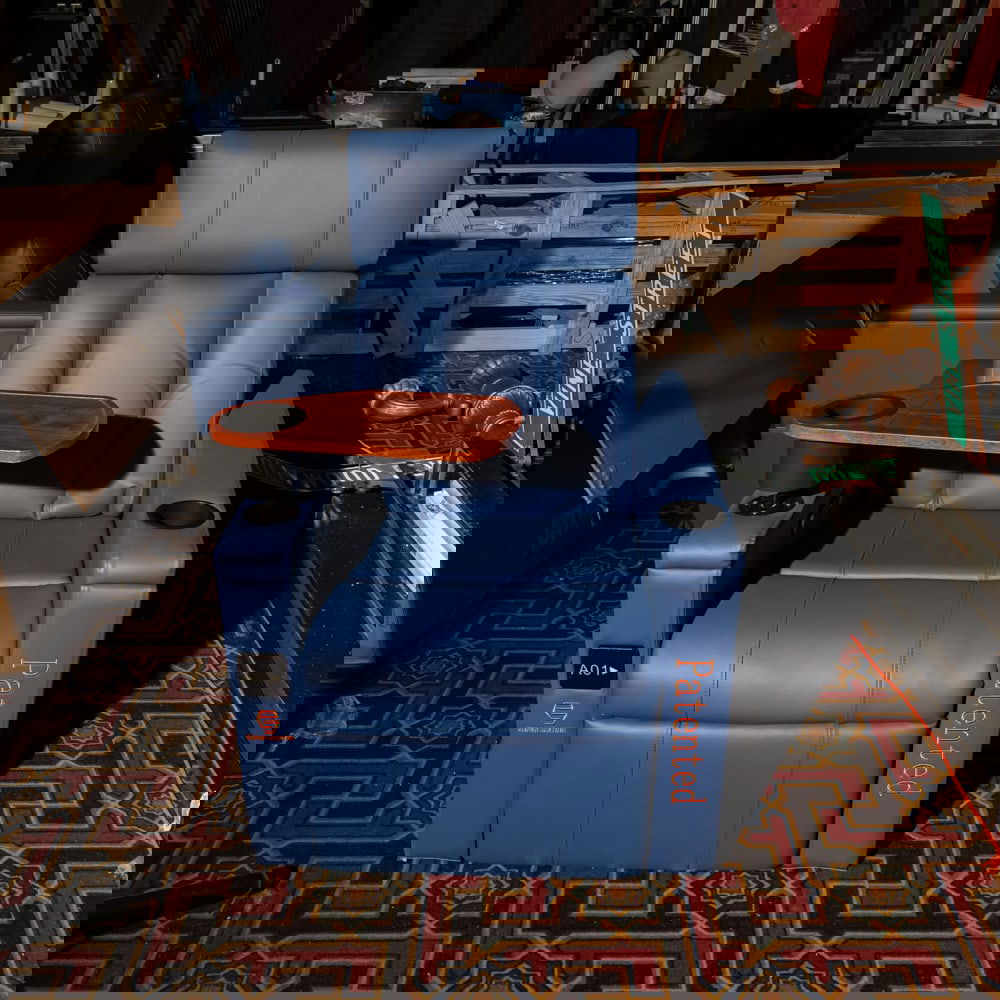 Blue Leather Cinema Recliner w/ Tray: This is a professional-grade, modern cinema recliner upholstered in a vibrant blue leather or high-quality faux leather, featuring a integrated swivel wooden snack tray and dual cup holders. The