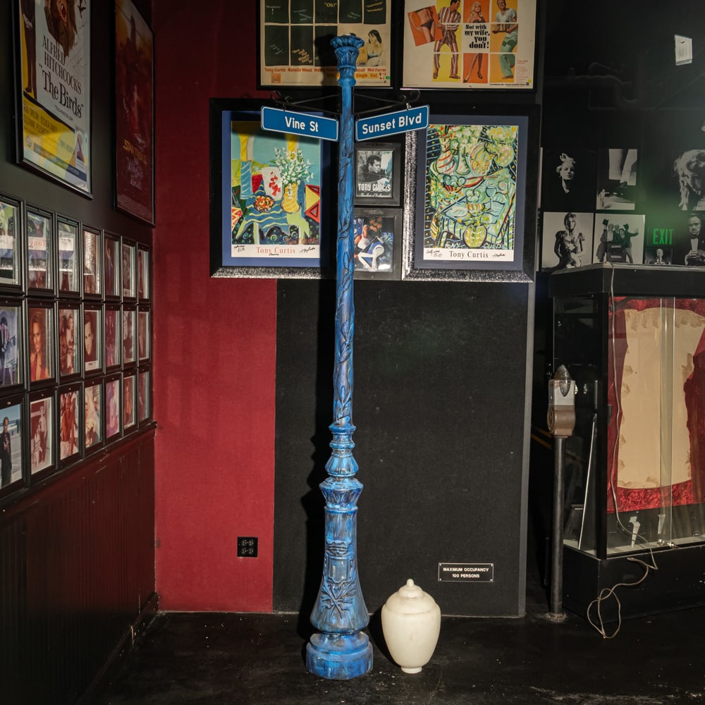 Light Post: 1920's Los Angeles style light post made of cast aluminum with plastic globe top and Sunset Blvd, and Vine St. signs attached. In overall good condition. Measures 8' tall. Buyer responsible for pickup