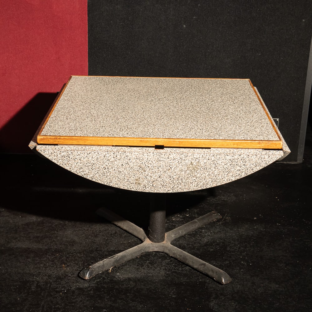 Drop Edge Restaurant Table: Restaurant style Formica top table converts from round to square by dropping edges. Measures 48" round when open, 36" square when closed. In good used condition on steel base. Please use photos to