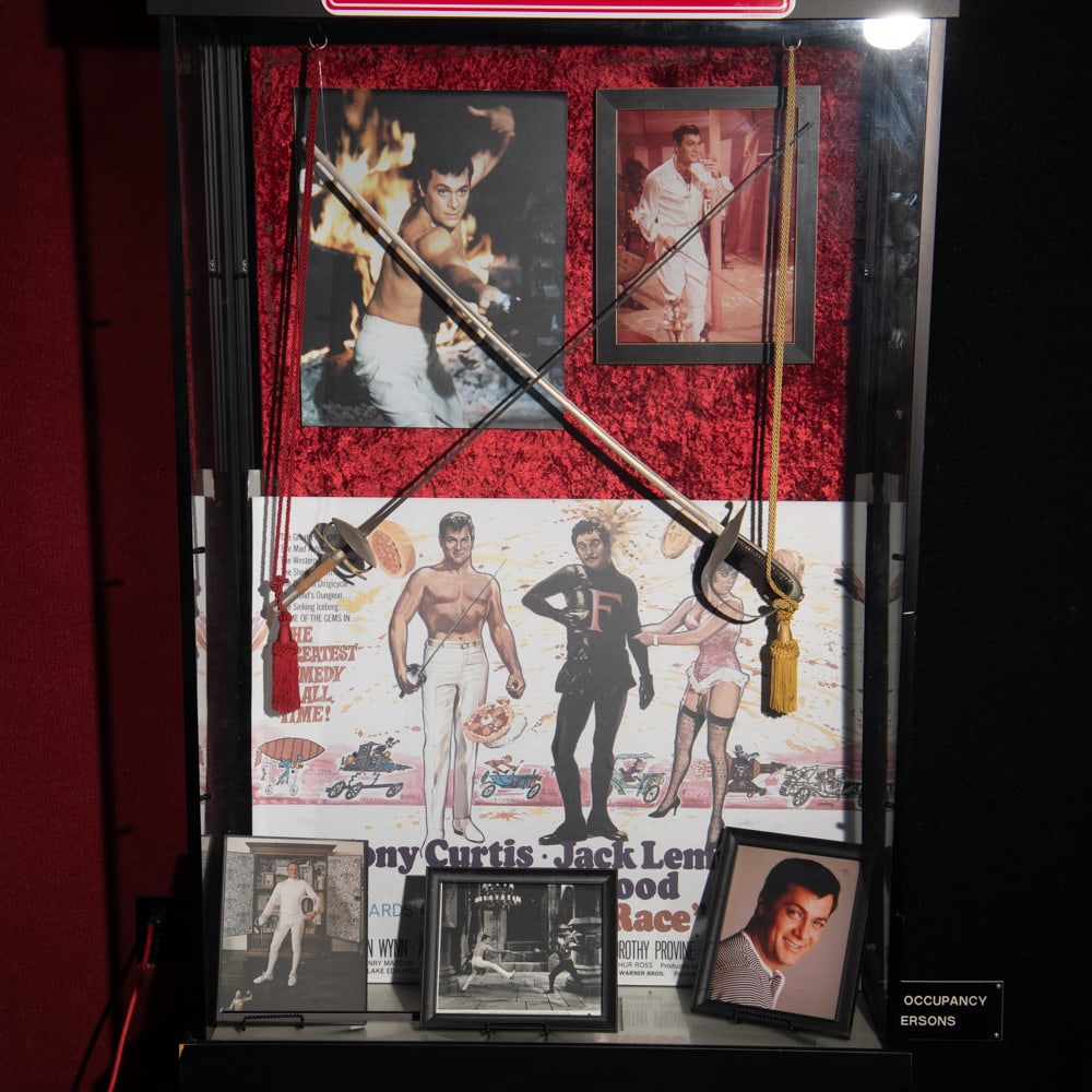 Tony Curtis The Great Race Sword Display: Includes 2 prop swords from the 1965 comedy movie, The Great Race starring Tony Curtis, Jack Lemmon, Natalie Wood. Also includes an advertisement for the Great Race, 4 studio photographs of Curtis