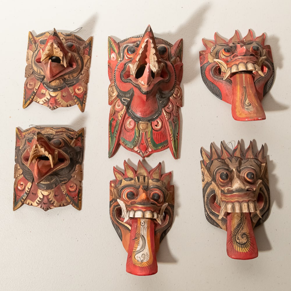 Hand-Painted Balinese Garuda Wooden Masks (6): This collection features six (6) vibrant, hand-carved wooden masks, masterfully crafted in the tradition of Balinese or Javanese folk art, likely depicting the mythical bird-creature Garuda and other