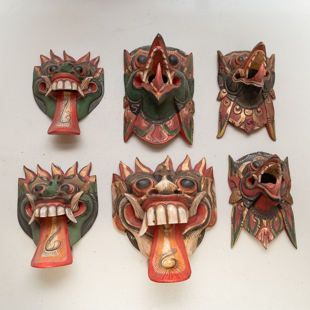 Hand-Painted Balinese Garuda Wooden Masks (6): This collection features six (6) vibrant, hand-carved wooden masks, masterfully crafted in the tradition of Balinese or Javanese folk art, likely depicting the mythical bird-creature Garuda and other