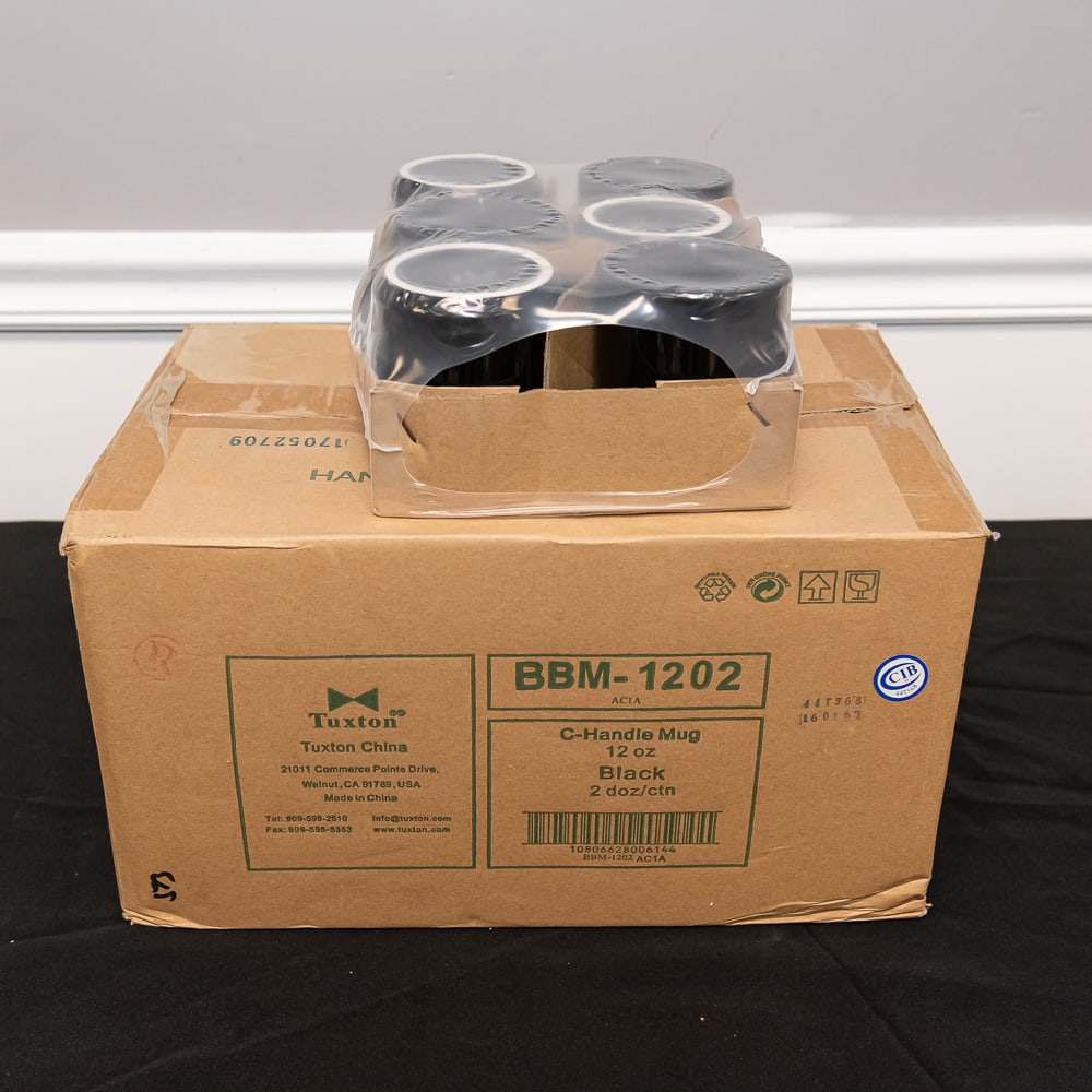 30 Tuxton Black C-Handle Mugs 12oz: This lot features a full case of 30 professional-grade "C-Handle" mugs manufactured by Tuxton China, a staple in the restaurant and hospitality industry known for durability and classic design. These