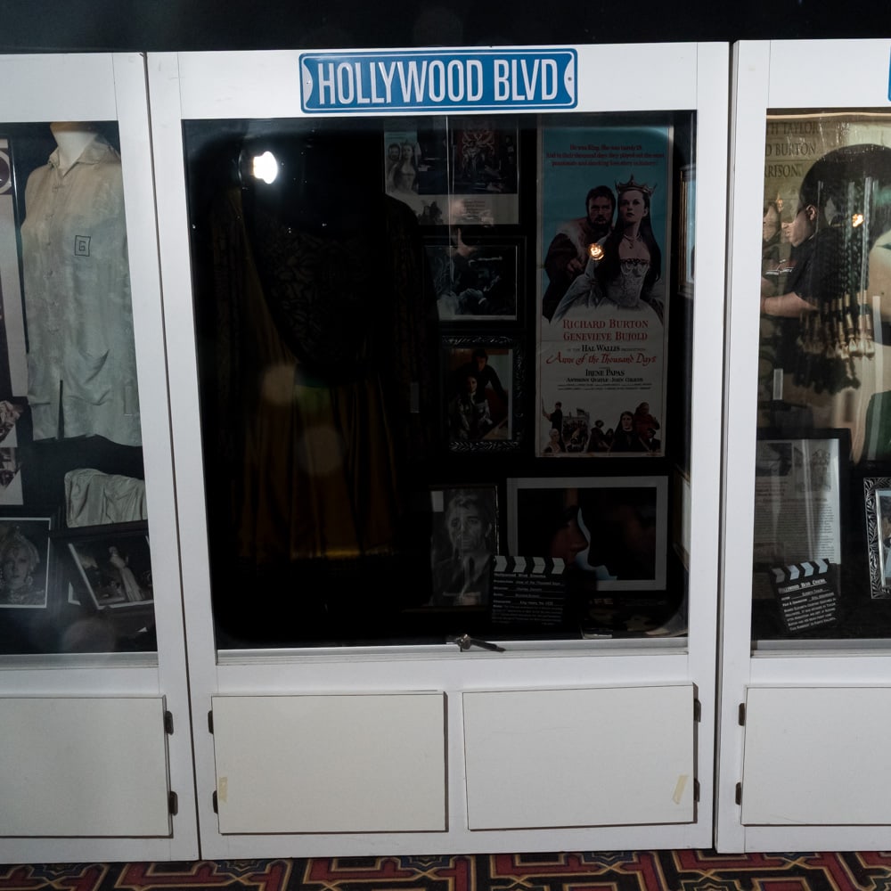 Tall Lighted Display Case: Lighted white Formica display case with 2 sliding glass front entry doors. Cabinet has 2 door storage below. In used condition. Measures 76" tall,50" wide, 20" deep. Please use photos to judge conditi