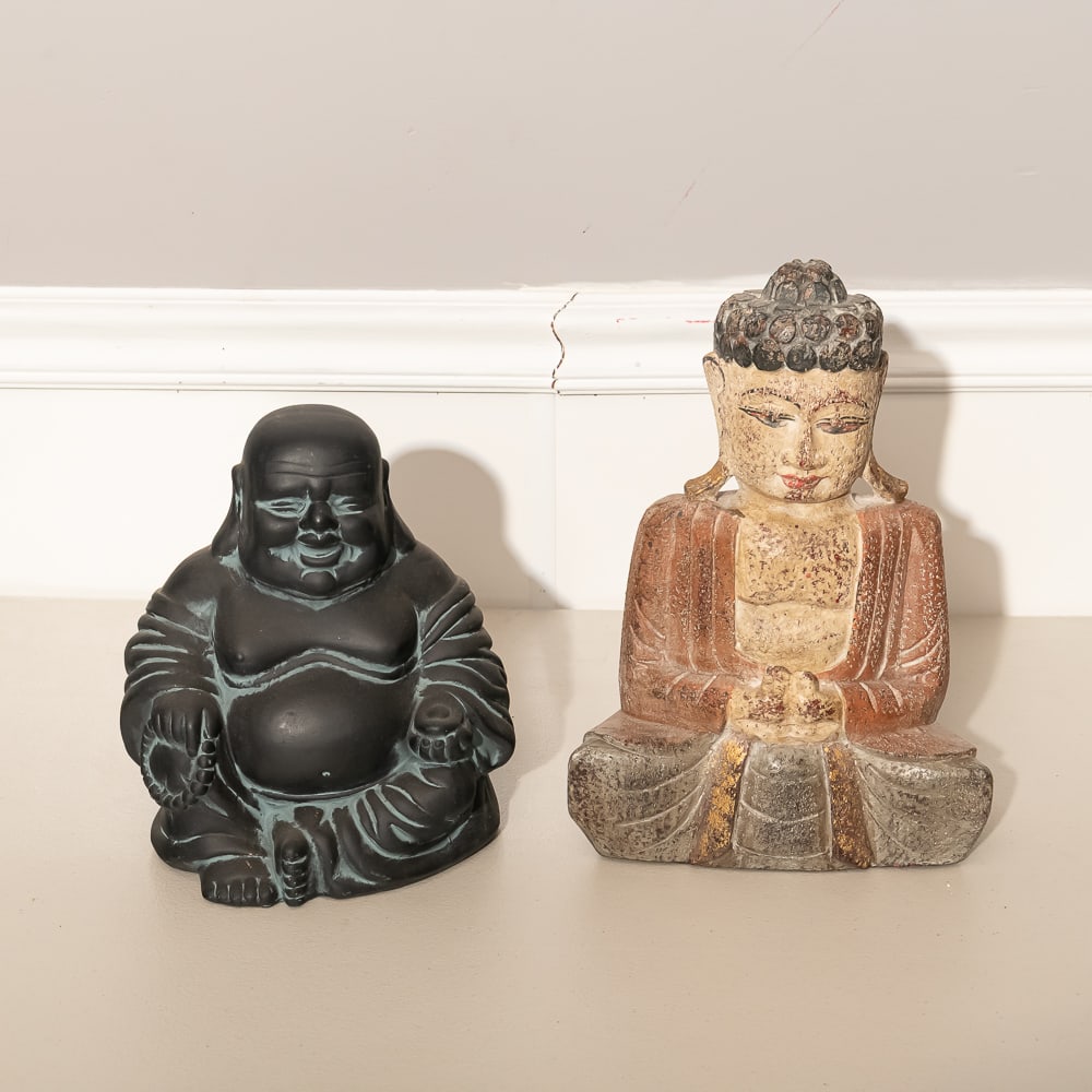 Set of 2 Buddhas: Wood & Ceramic: This pair features two distinct representations of Buddhist iconography, perfect for a collector of Eastern spiritual decor. The taller figure is a hand-carved wooden Seated Buddha, likely of Southeas