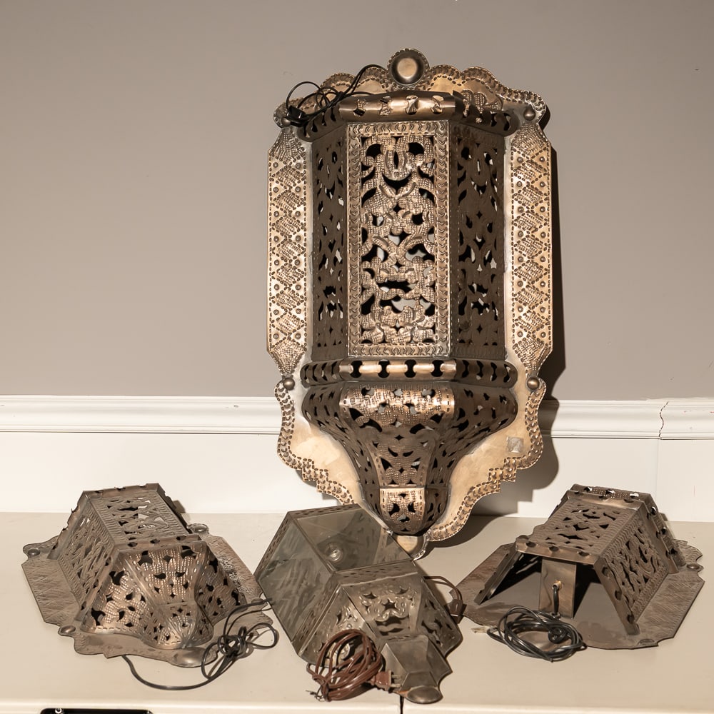 4pc Ornate Pierced Tin Wall Sconce Set: This striking architectural set of four Moroccan-style wall sconces is crafted from hand-pierced tin, a classic folk-art medium that lends these pieces a rustic yet sophisticated Moorish aesthetic. Th