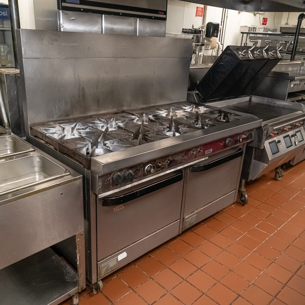 Southbend 10-Burner Commercial Gas Range: As a veteran of the restaurant equipment trade, I recognize this "workhorse" immediately. This is a Southbend S60DD 60-inch commercial gas range featuring ten non-clogging burners and a double standar