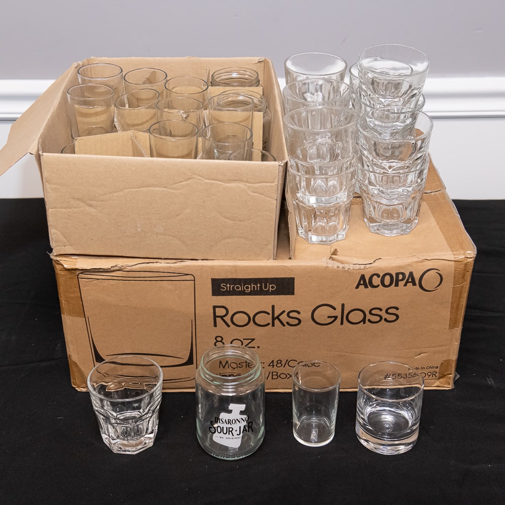 86 Miscellaneous Drinking Glasses: Assorted Acopa Rocks & Specialty GlassesThis collection features a professional-grade set of barware, primarily anchored by a partial case of Acopa "Straight Up" 8 oz. rocks glasses. These are classic