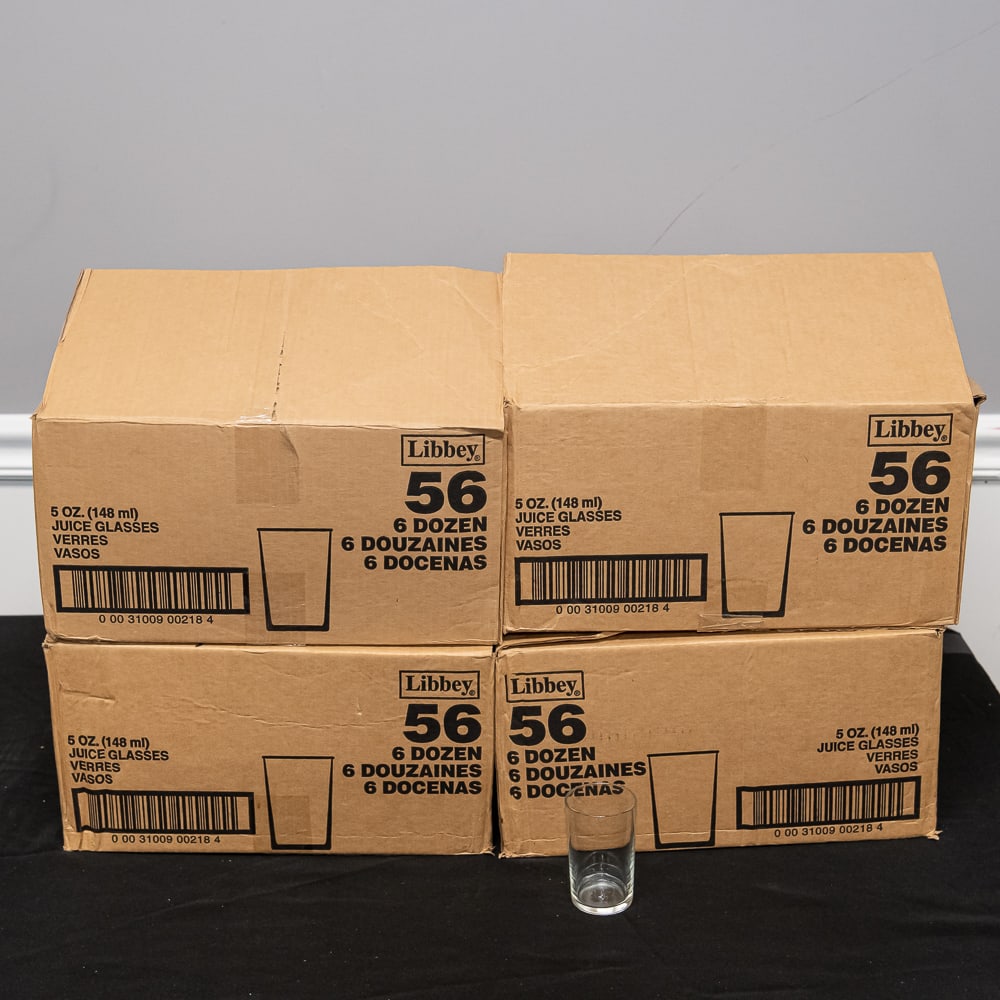 185 Libbey 5oz Juice Glasses: This impressive bulk lot features four original factory cases of Libbey Glass Company "No. 56" juice glasses, totaling 185 clear glass vessels. Each case originally held 6 dozen (72 pieces) of these c