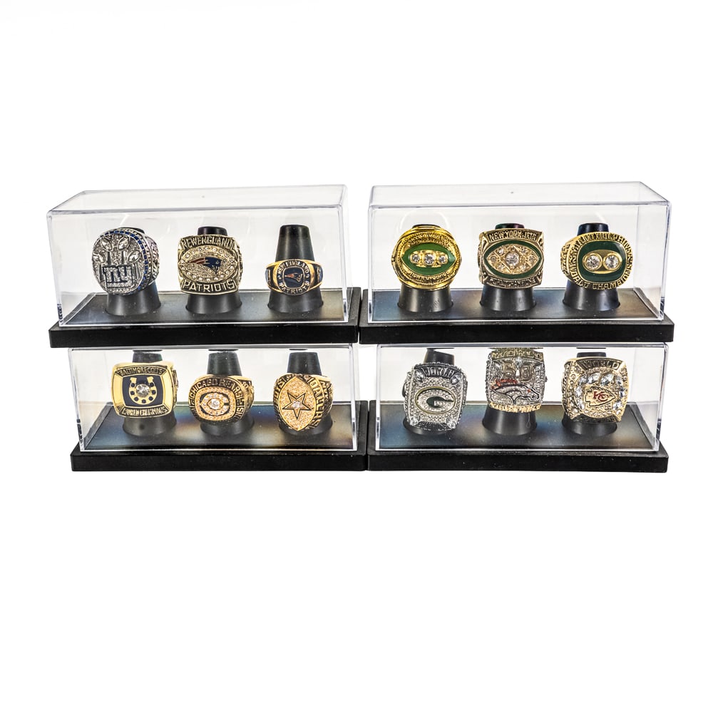 (12) Assorted NFL Super Bowl Championship Rings: Collection of (12) assorted NFL "Super Bowl Championship Rings" including The Chiefs, Broncos, Green Bay Dallas Chicago New England and several others showcased inside displays. Striking eye catching