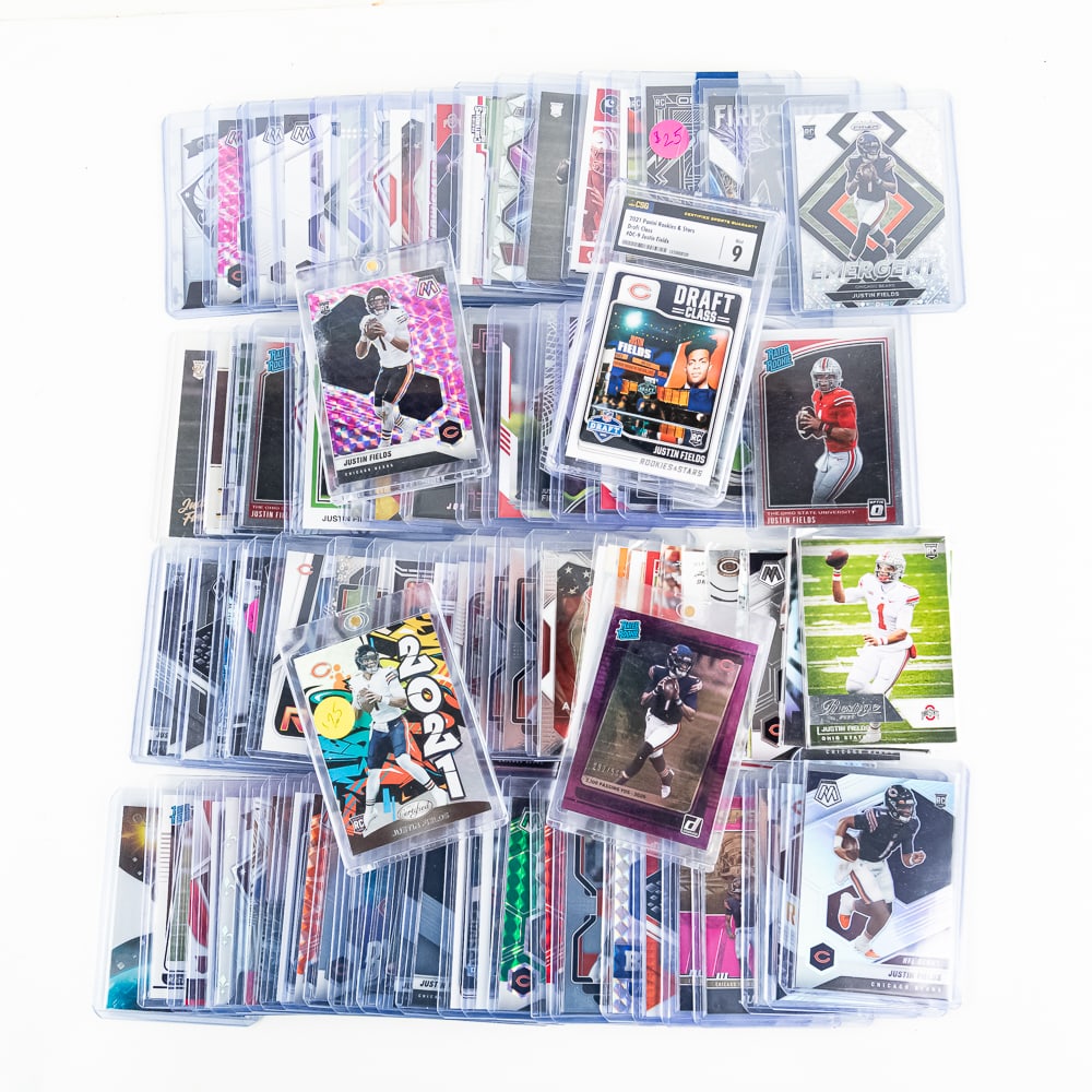 (100) Assorted Justin Fields Football Cards RC CSG: Collection features 2021 Panini Rookies & Stars Draft Class #DC-9 Justin Fields CSG 9 & (99) assorted Justin Fields NFL football cars. All in NM-MT +/- showcased inside top loaders or magnet one touch