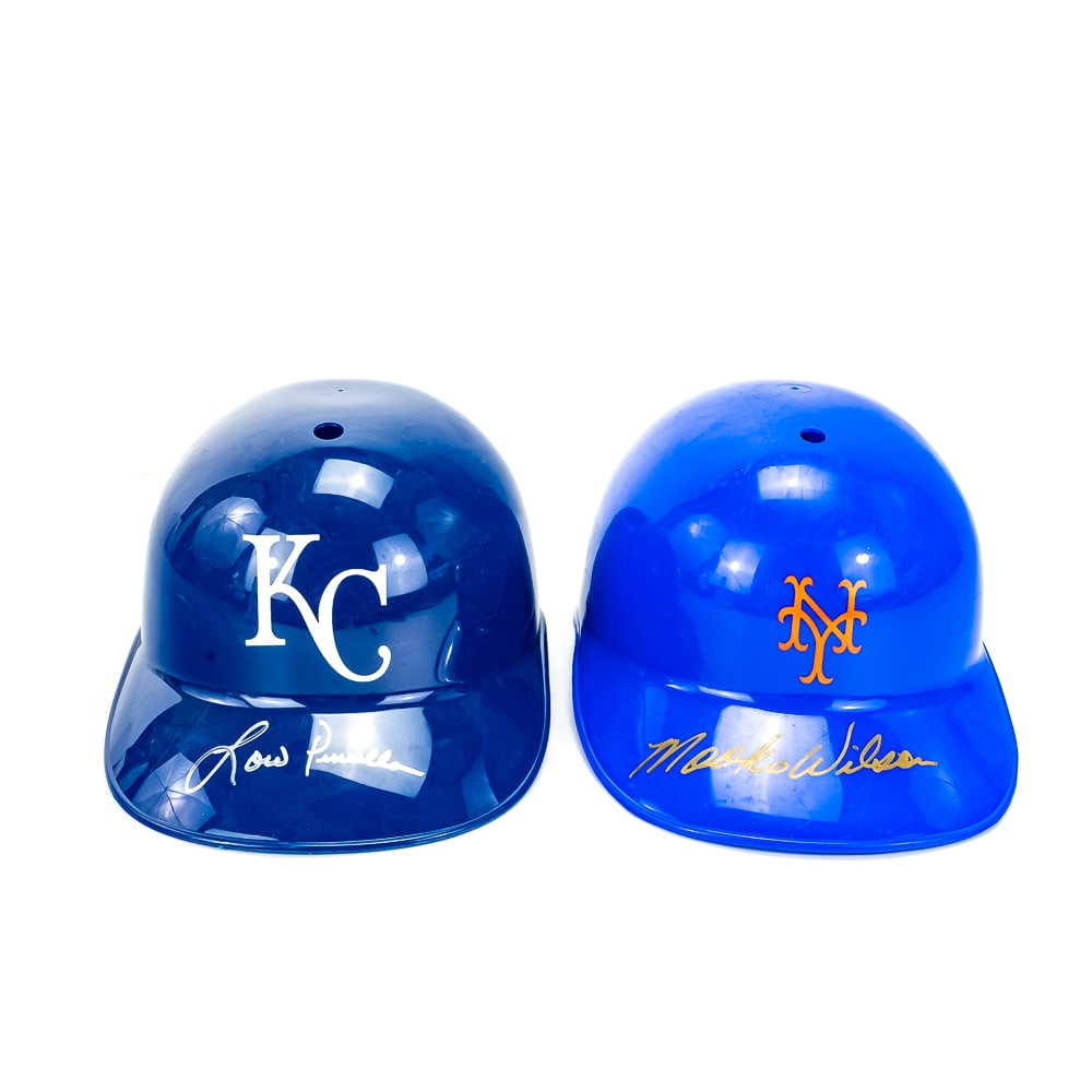 Lou Piniella & Mookie Wilson AUTO Batting Helmets: Collection showcases Mookie Wilson Autographed NY Mets plastic batting helmet & Sweet Lou Piniella Kansas City Royals plastic batting helmet. Both show minor surface scratches noticeable under close