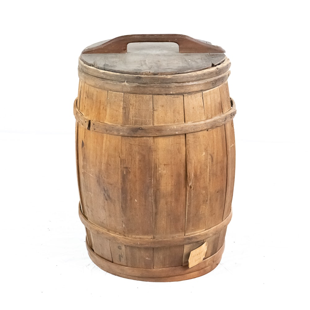 Vintage Large Wooden Cracker Barrel: Vintage Large Wooden Cracker Barrel, constructed from wood staves with metal banding, shows signs of age with a damaged/repaired section on one side, lid is cracked and a chunk missing from the side,