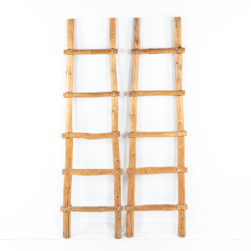 (2) Rustic Kiva Ladders: Two slightly tapered, rustic crafted, decorative Kiva ladders, made from pine wood and rawhide strapping. Overall good condition, 17" W x 60 1/2" HOwn a piece of history from the Donley's Wild West