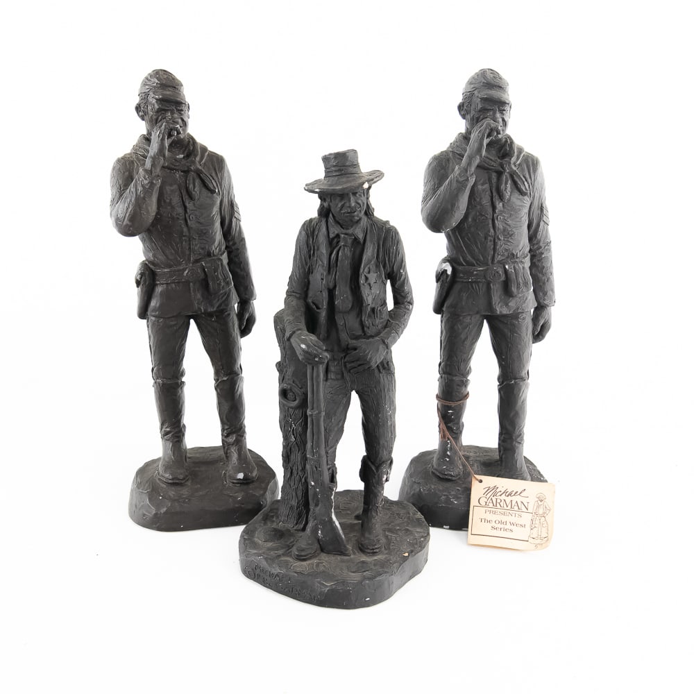 (3) Michael Garman John Wayne & Cowboy Sculptures: (3) Michael Garman John Wayne & Cowboy Sculptures, two John Wayne as US Cavalry Sergeant bronzetone statues, metal resin, approx 12" tall, a 1982 Garman cowboy or gunslinger, 10.5" tall, minor chips t