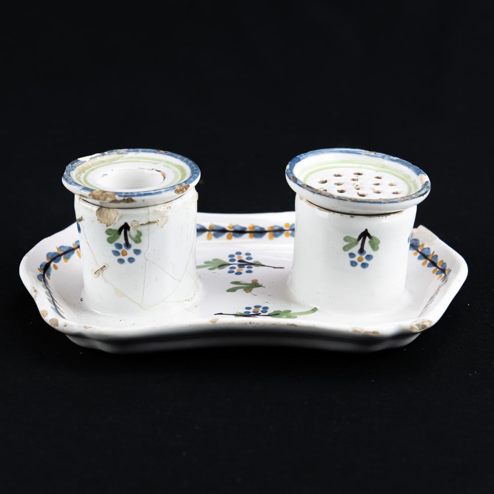 Antique Faience Pottery Inkstand Set: This hand-painted faience inkstand set, likely 18th or 19th-century French or Dutch, features a scalloped-edge tray with a blue and yellow vine border and floral sprigs. It includes two cylindrical po