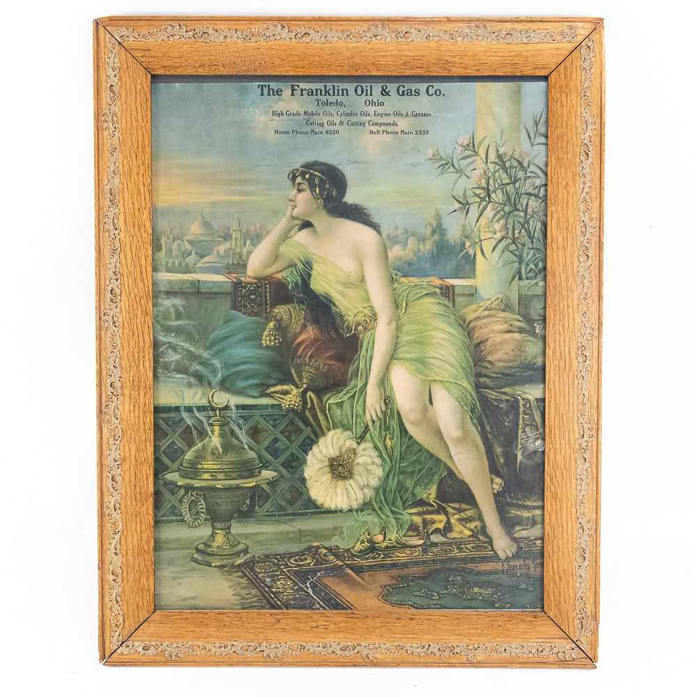 Framed Antique Advertising Franklin Oil & Gas Co.: A nicely framed cardboard advertising of a scantily clad dressed maiden. Advertising a gas and oil company out of Toledo OH. A small split in artwork at bottom area and some slight discoloring in wood