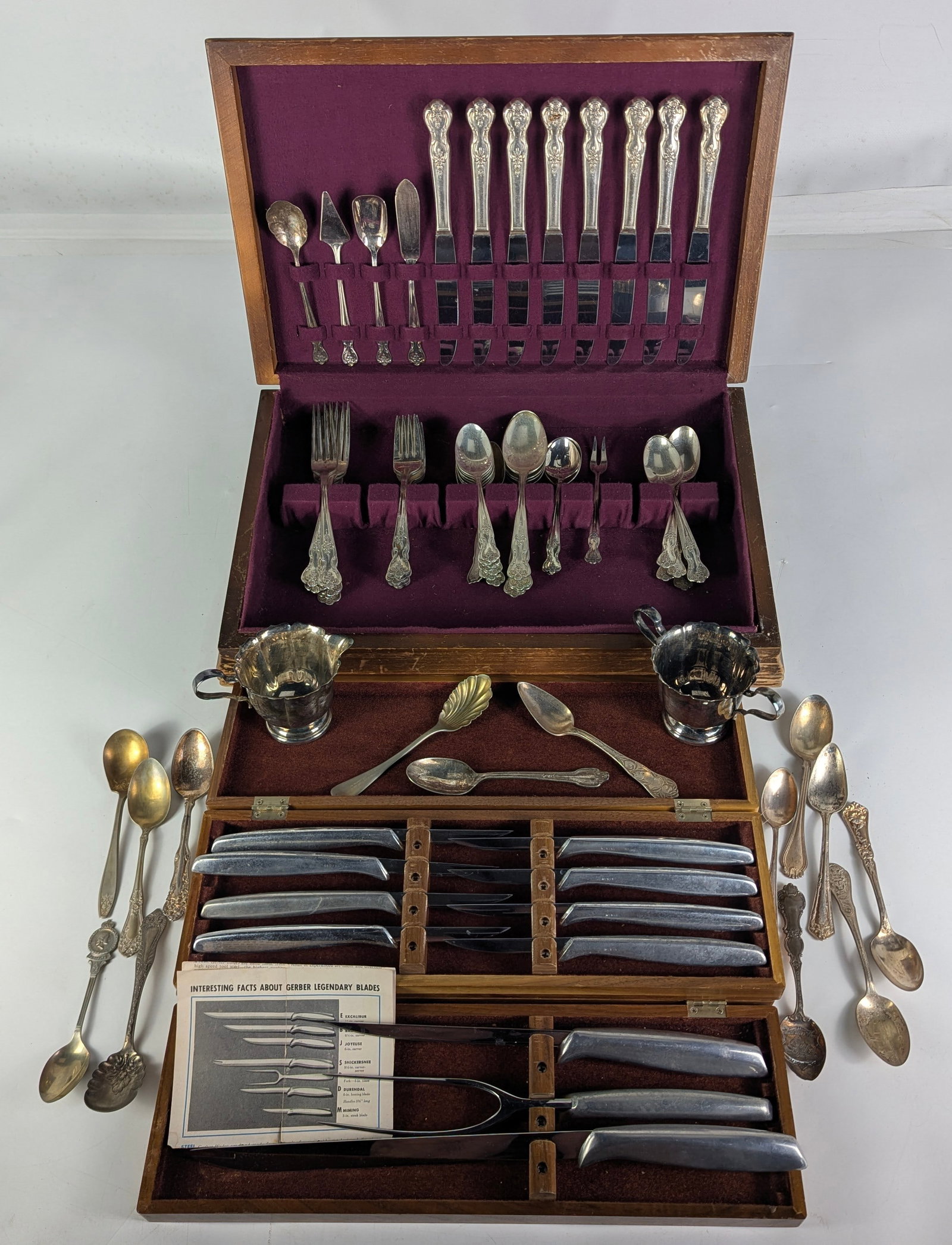 Gerber Legendary Blades Knife & Carving Set wPlate: Collection features vintage Gerber "Legendary Blades" Miming Steak Knife Set & 3 piece carving set both featured inside original Walnut cases, (14) assorted silver plate Souvenir Spoons, (52) Piece Wi
