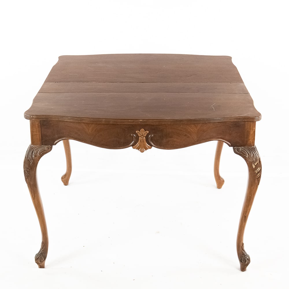 French Provincial Style Console Table: This elegant French Provincial style console table features a striking serpentine front and classic cabriole legs adorned with detailed acanthus leaf carvings and a central fleur-de-lis motif on the a