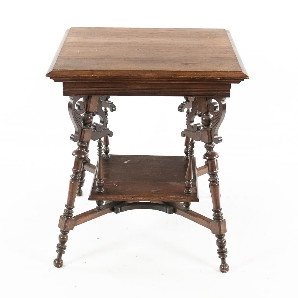 Victorian Eastlake Walnut Tiered Table: This elegant parlor table is a quintessential example of the American Eastlake movement from the late 19th century, characterized by its move toward rectilinear forms and delicate, machine-carved