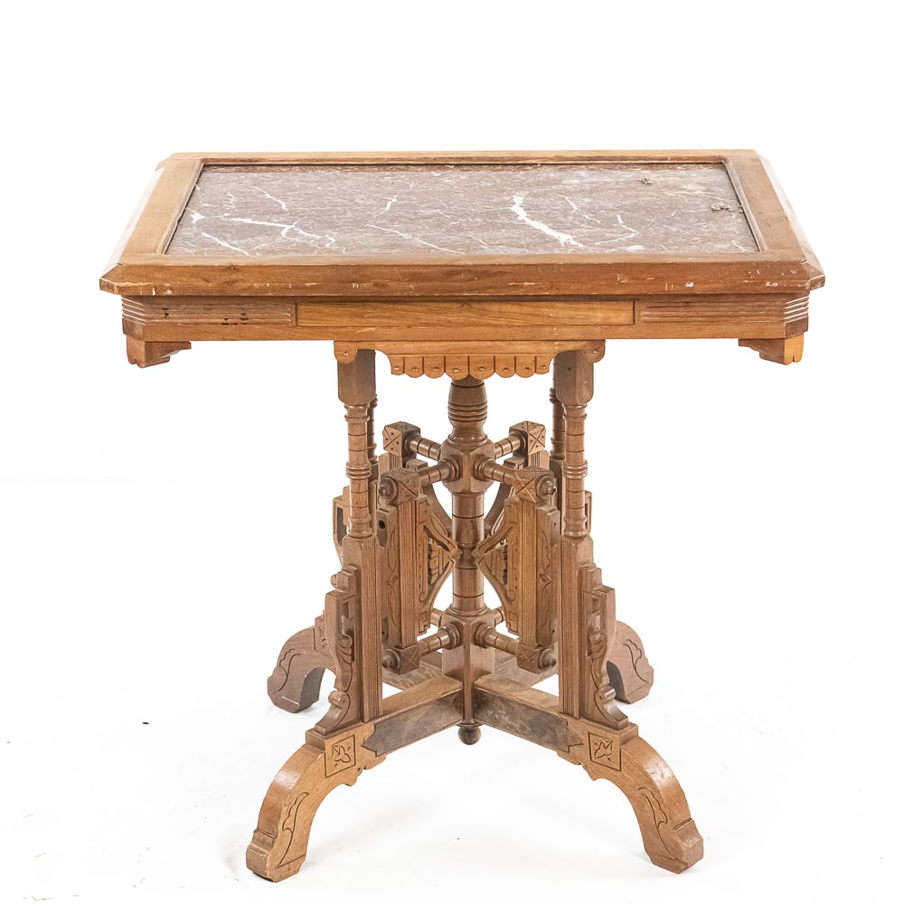 Victorian Side Table With Marble Top: Solid walnut with fancy filigree 4 leg base. Fancy apron on top with pink and white inset marble top. In good condition. Measures 30 1/2" x 22" x 29"Note: Pickup/ Transport required. Contacts