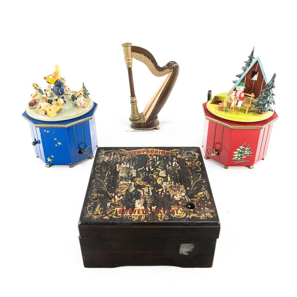 Four Antique and Vintage Music Boxes: This curated collection offers a fascinating cross-section of mechanical musical history, featuring a premier 19th-century German Symphonion disc player alongside mid-century whimsical animations. The