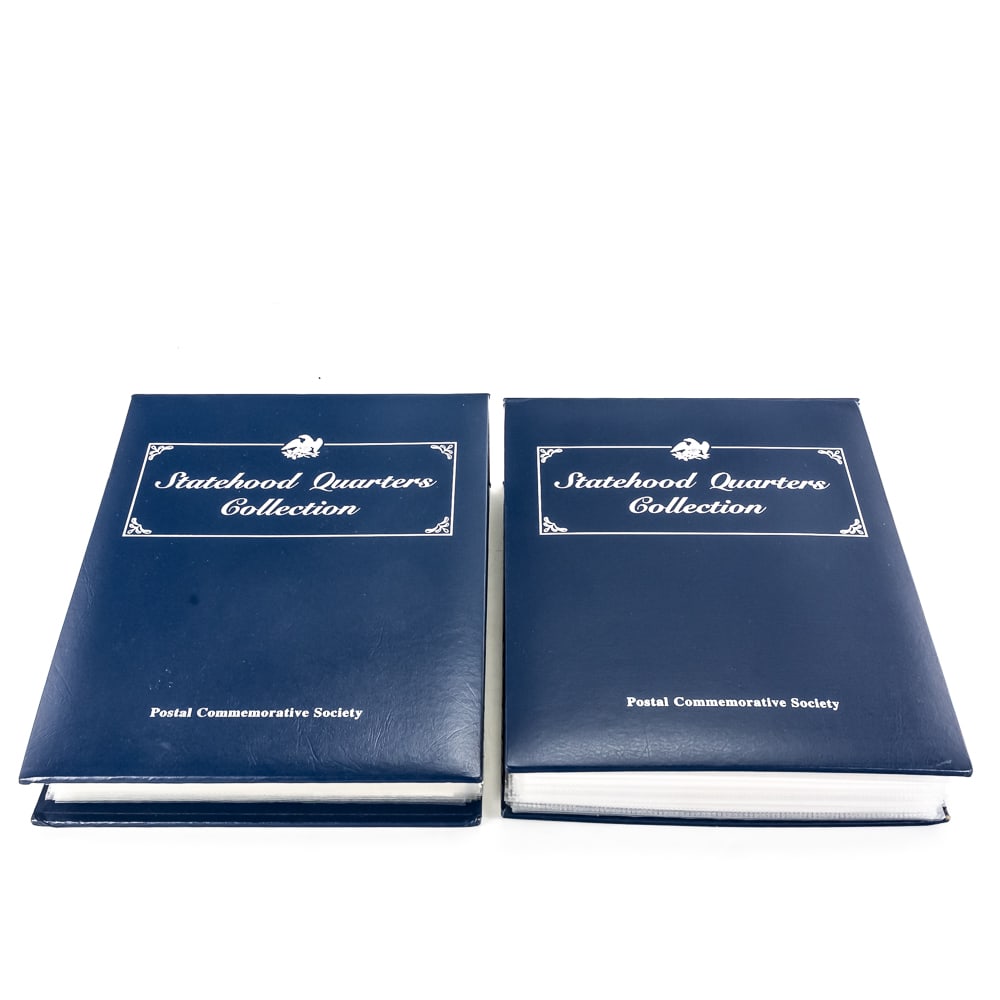 Postal Commemorative Society Statehood 25C V I &II: 10% Buyer Premium + Online/Credit Card Fees if applicable on Coins & Currency. Postal Commemorative Society Statehood Quarter Collection volumes I & II. Appears mostly complete volume I with 25 pages 