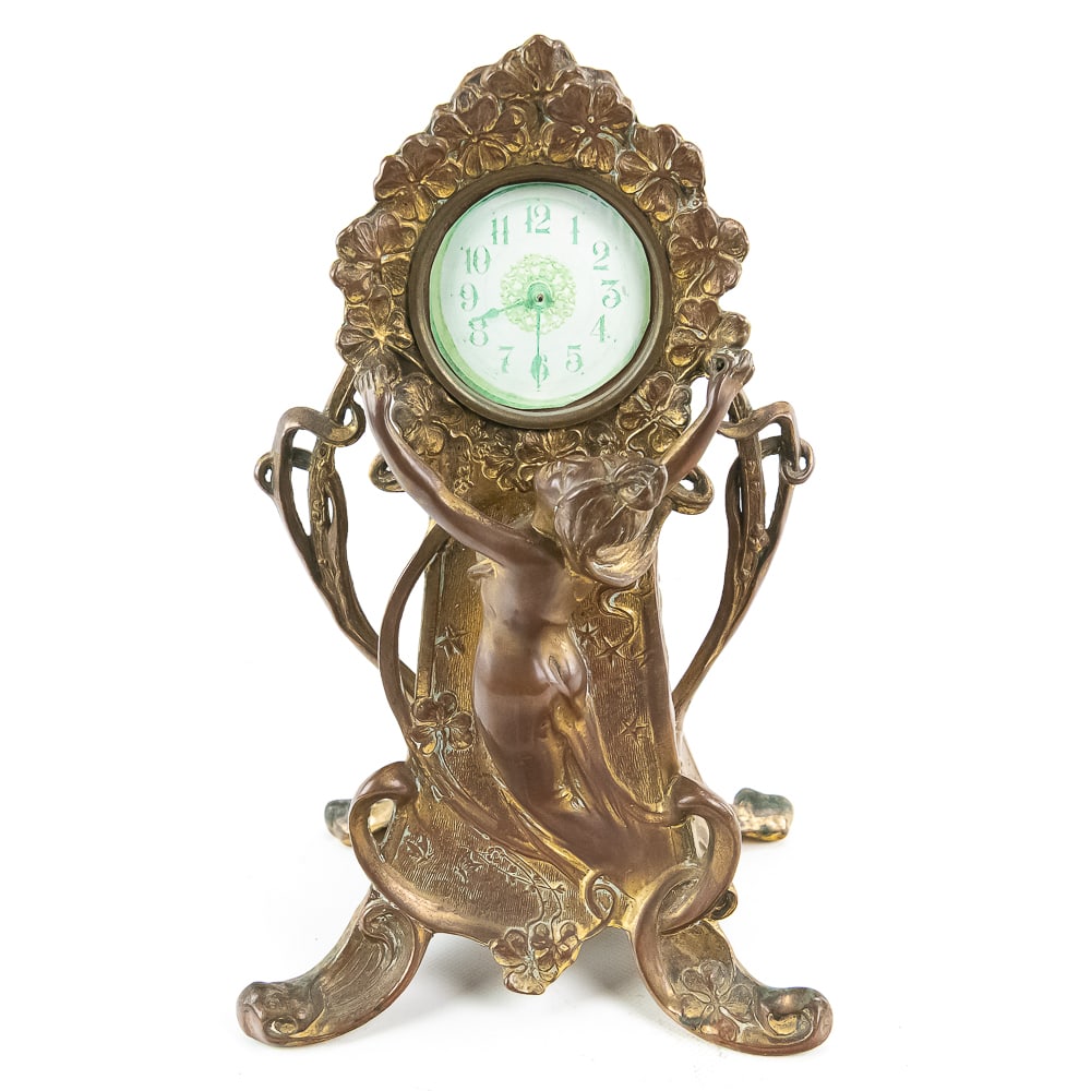 Art Nouveau Gilt Bronze Maiden Clock: An elegant example of the Art Nouveau movement, this mantel clock features a graceful maiden figure cast in bronze, surrounded by flowing organic lines and clover motifs characteristic of the late 19t