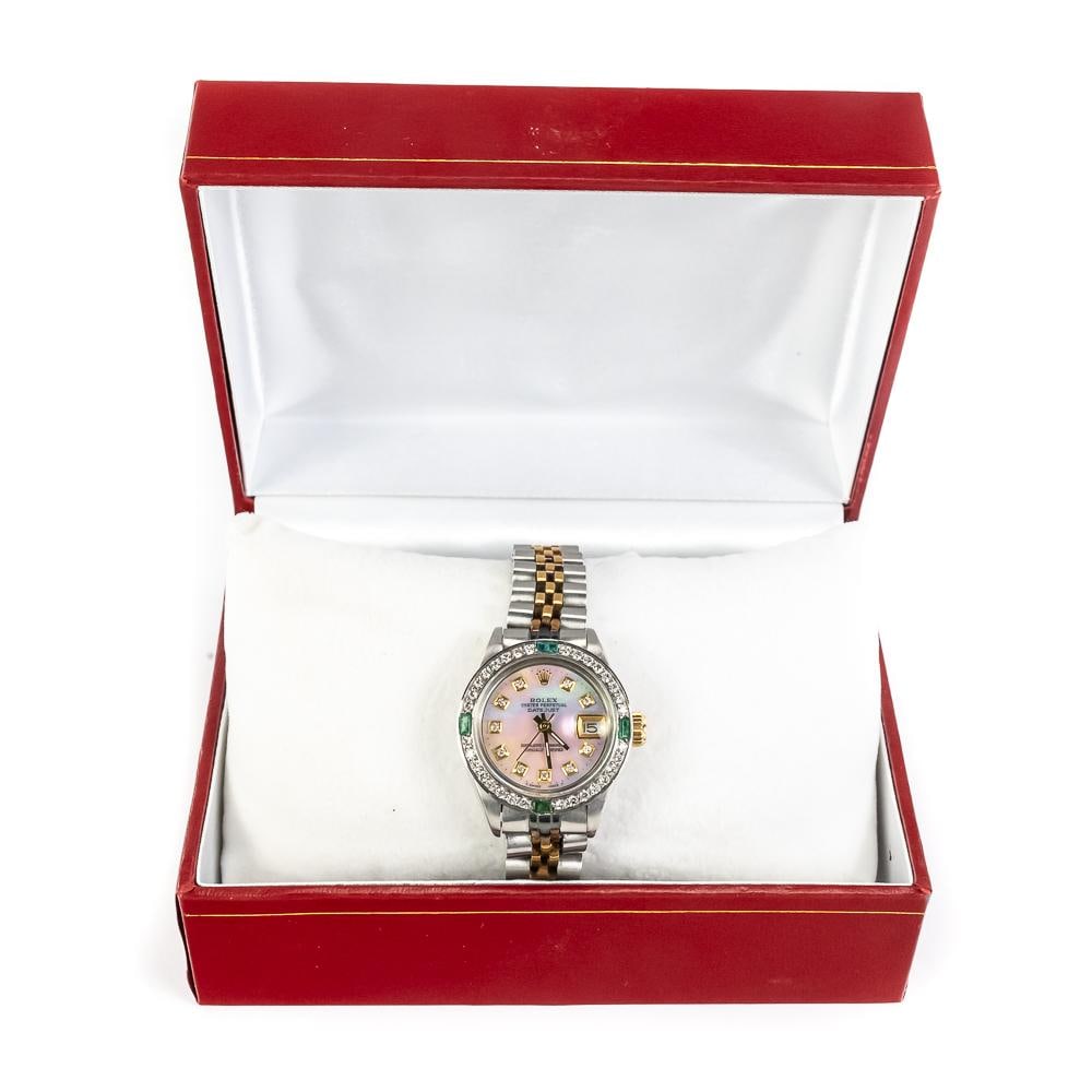 1980s Ladies Diamond & Emerald MOP Rolex Datejust: 1980s Ladies Rolex Datejust perfectly paired with an attractive Mother of Pearl dial with diamond and emerald highlighted bezel on a two tone bracelet. Presents extremely well with minor signs of age 