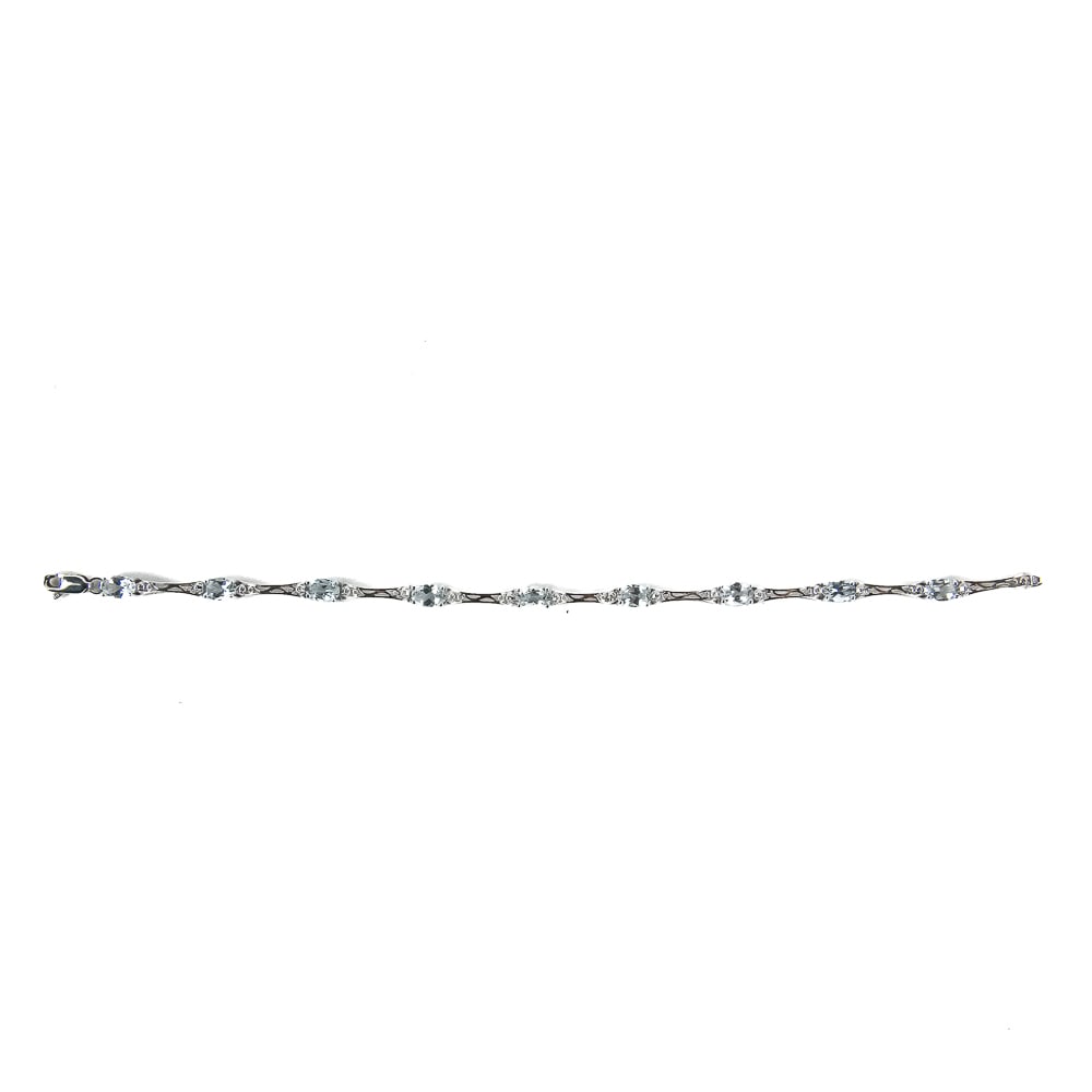 10k White Gold Aquamarine Diamond Tennis Bracelet: Lovely Ladies 10k White Gold Aquamarine tennis bracelet with diamond accents. Presents perfectly in excellent overall condition; like new. Approximately 7" in length with a total weight of 5.9 grams. 