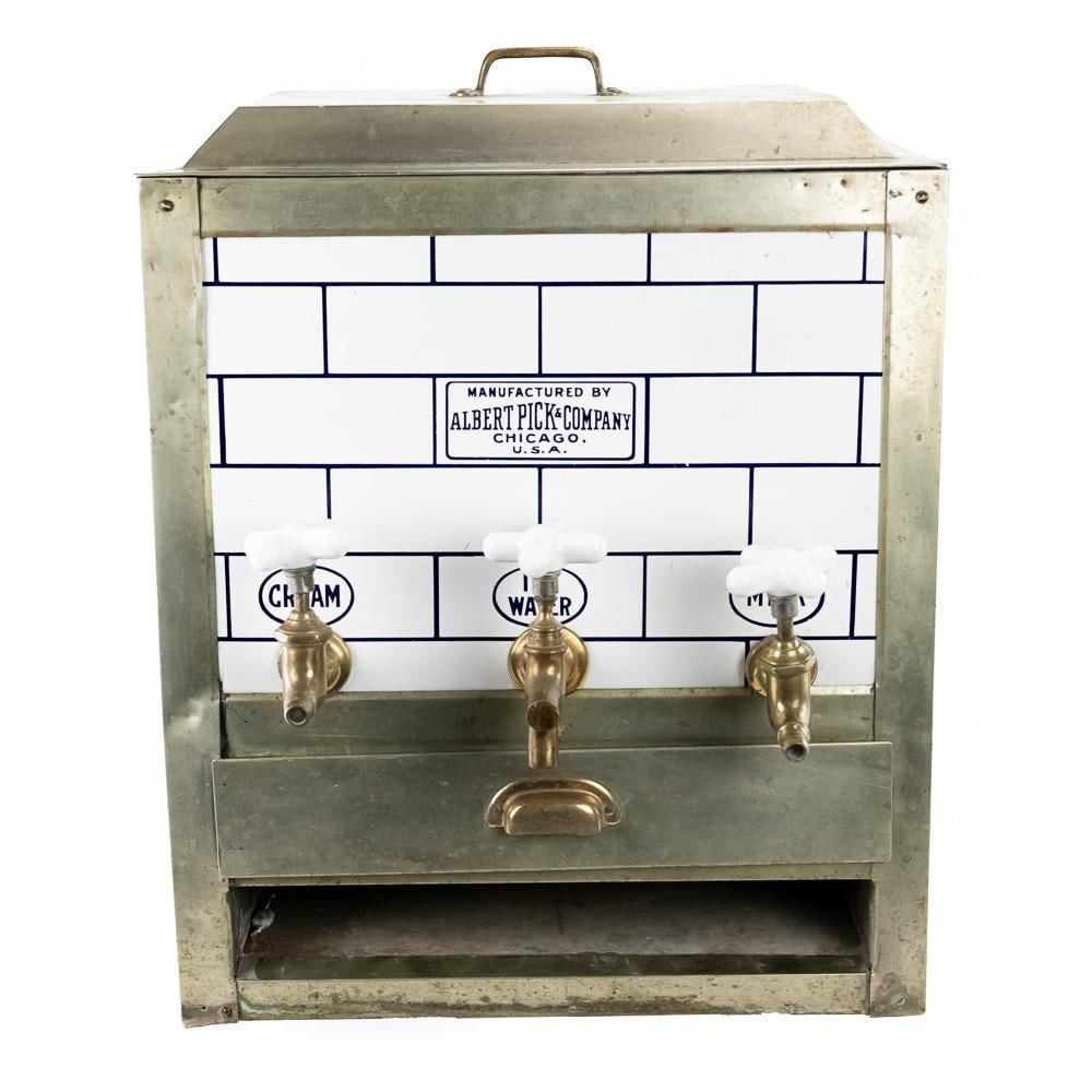 Soda Fountain/Diner/Cafe 3-Spigot Dispenser: An unusual stainless and porcelain, 3 compartment dispense. Manufactured by The Albert Pick and Co., also embossed on the front of the item. Has original lid, stainless trim (one piece missing on lowe