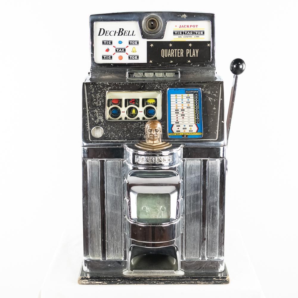 Jennings 25 Cent Deci-Bell Slot Machine: Original in good condition, showing some wear with scuffs, scratches and nicks. Front chrome is in rough to fair condition. Has lock, key and coin box. Works as it should. 16" x 15 1/2" x 27 1/2"Note: