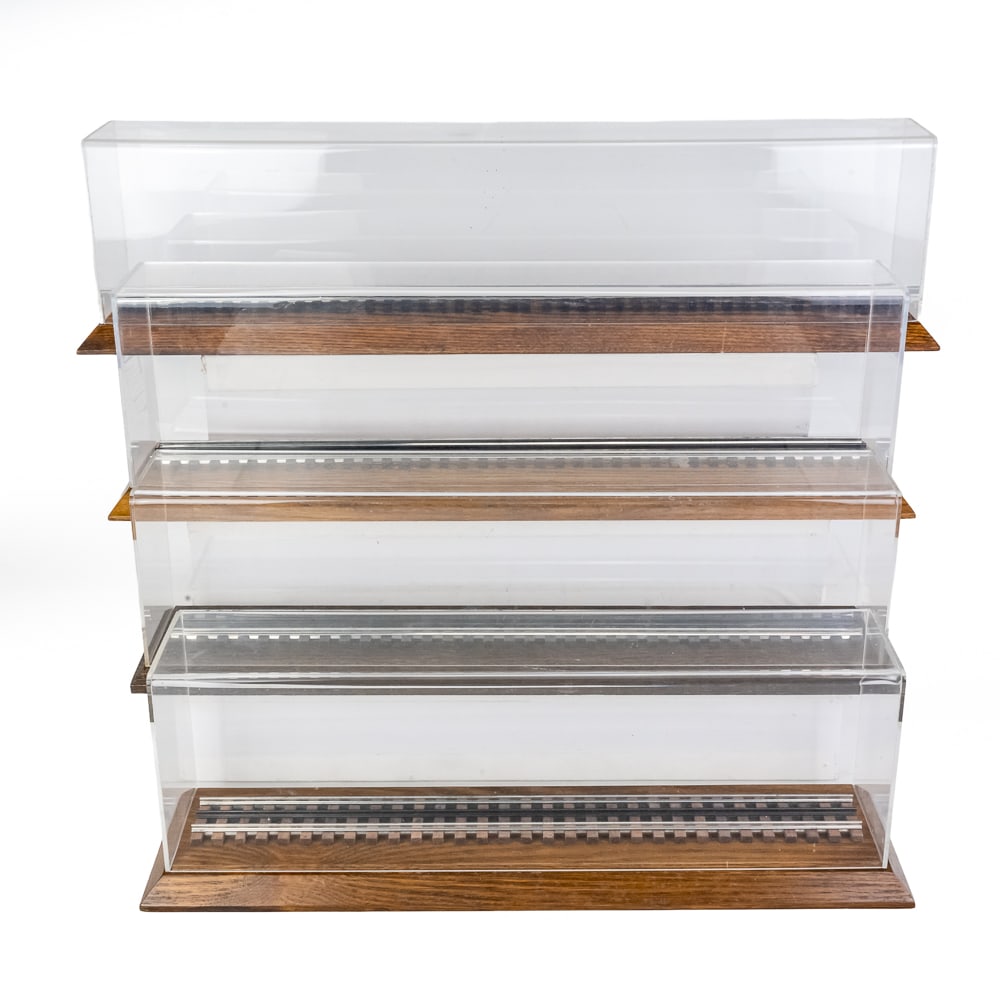 (4) Toy Train Diesel Engine Locomotive Displays: Collection of (4) acrylic and wood toy train Engine Locomotive displays; 7"t x 5"d x 21.5"l; 6.5"t x 5"d x 23"l: 7"t x 5.5"d x 25.5"l & 7.5"t x 5.5"d x 30'l. Very good overall condition with light