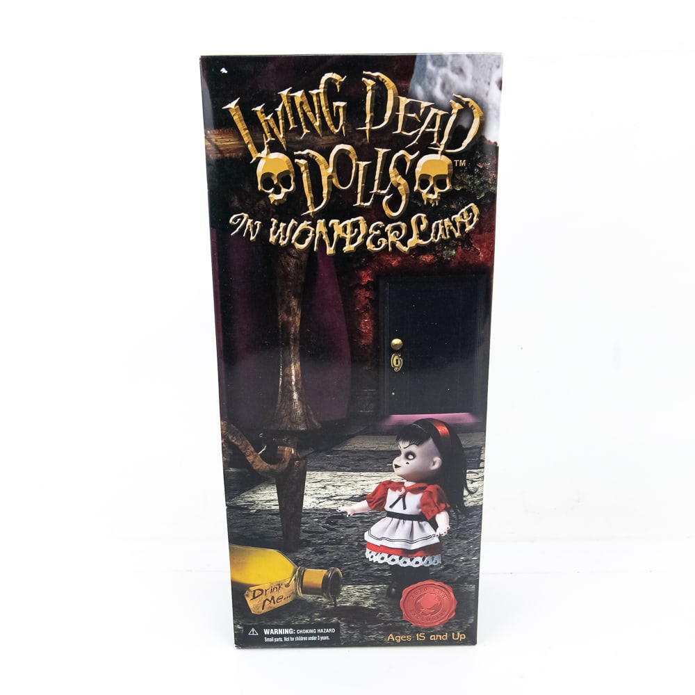 Living Dead Doll NIB Wonderland A Drink To Shrink: NIB In Wonderland A Drink To Shrink... And A Cake To Grow Action Figure. Hard to come by collector Living Dead Doll; perfect gift idea. Perfect addition to your collection, please use photos to judge